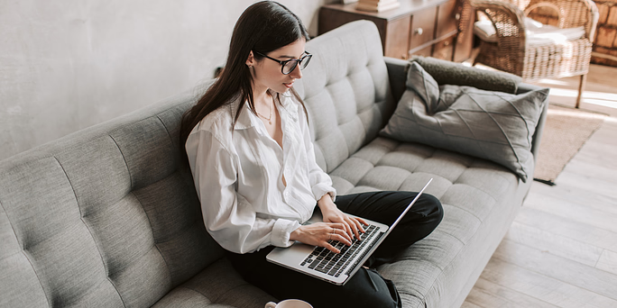 Woman searching on her laptop "Self-Induced Miscarriage: Is It Safe?"