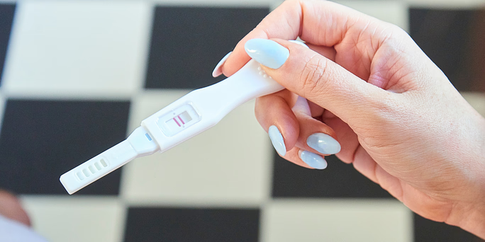 Woman asking herself "How do pregnancy tests work?"