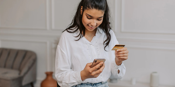 woman in white viewing phone